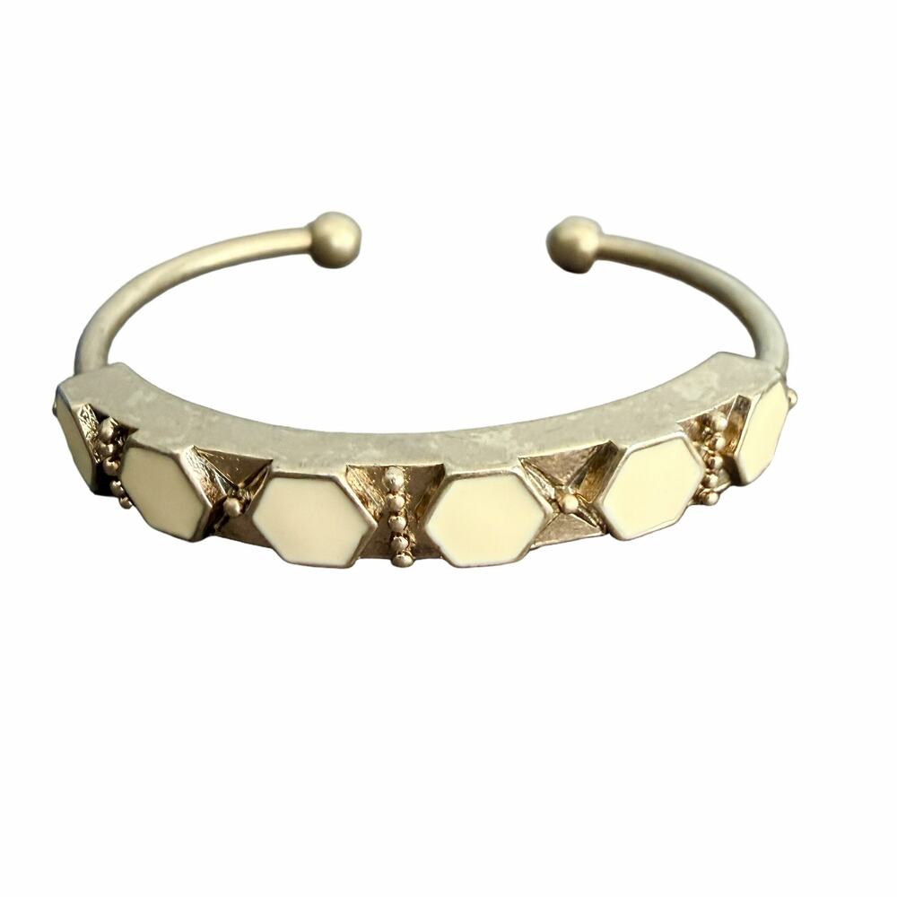 Vintage gold tone open cuff bangle with white geometric hexagon enamel inlays
